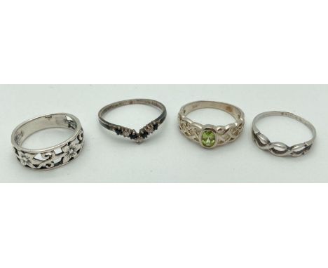 4 silver band style and stone set dress rings. A band with twist detail to top, a band with pierced floral work, a wishbone r