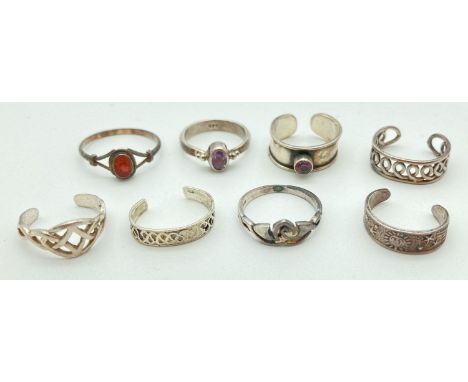 A collection of 6 silver and white metal toe rings together with 2 child's white metal dress rings. Toe rings include Celtic 