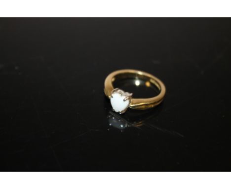 AN 18CT GOLD DRESS RING SET WITH A HEART SHAPED OPAL