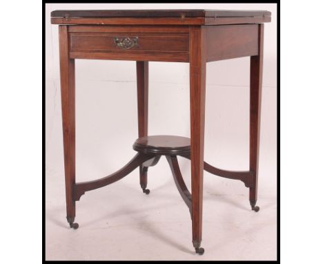 An Edwardian / late Victorian marquetry inlaid  rosewood envelope card games table. The table with green baize top having  si