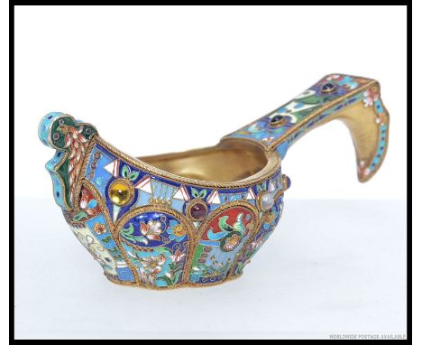 A Russian gilded silver and enamel Kvosh being decorated with individual cartouche panels, inset coloured stones. Impressed m