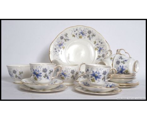 Colclough - A mid 20th century tea service by Colclough decorated with blue flowers consisting of trio's, creamer, sugar bowl