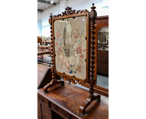 A Victorian firescreen, a good example with barley twist supports, and scrollwork frame standing on cabriole legs, the tapest