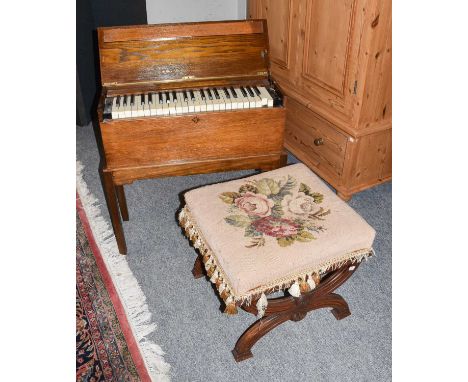 An early 20th century oak cased Harmonium, a 19th century rosewood X-frame stool, a framed deed, a fire guard, (4)