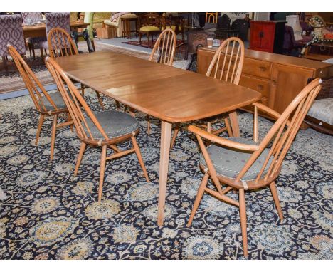 An light elm ercol 1960's suite comprising a dining table, fully extended, 224cm by 81cm by 71cm, sideboard, 156cm by 43cm by