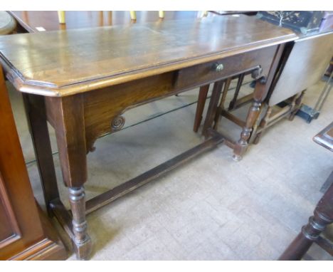 An Oak Console Table, with decorative carving, approx 116 x 35 x 75 cms, turned legs with straight stretcher.