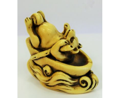 Meiji Period Japanese Netsuke, a comical ivory carved netsuke, depicting a reclining fox punting down the river, the punt dep