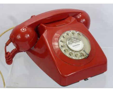 A Vintage Red Rotary Dial Telephone.