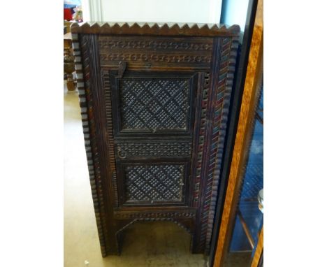 A North African Spice Cupboard, with decorative carving, the interior fitted with single shelf,  approx 58 x 24 x 113 cms.