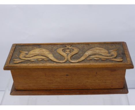 An Oak Stationery Box in the Art Nouveau style with decorative carving, architect's rolling ruler and a vintage truncheon. (3