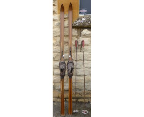 A Pair of Vintage Wooden Skis No. 10 11136 with original leather boot and metal binding.