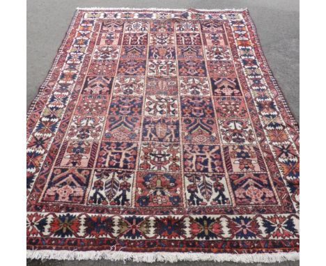 A Bakhtiar Vintage Woollen Carpet,  the carpet having chequered and floral design to panels and border approx 290 x 205 x 594