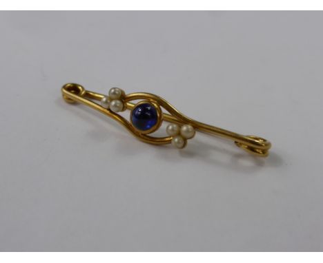 A Lady's 15 Ct Yellow Gold Cabochen Sapphire and Seed Pearl Brooch, wt 5.2 gms., 5.6 mm sapp, 6 x 2.5 pearls.