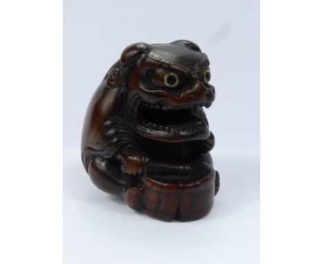 Meiji Period Japanese Netsuke, intricately carved box wood netsuke, depicting a Shi-Shi Masked Drummer, with ivory inlaid eye