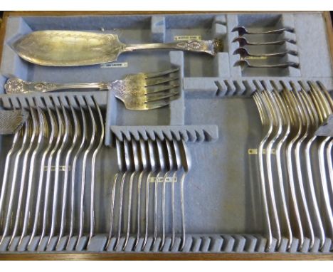 A Three Tier Oak Cased Set of Silver Plated Flatware, not entirely complete.