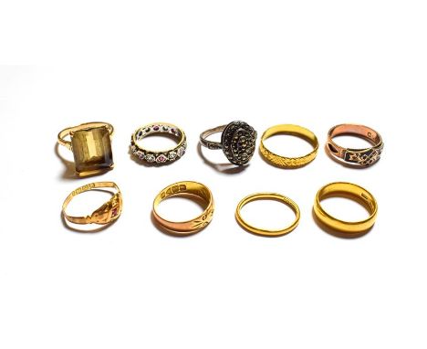 Two 22 carat gold band rings, one of of shape, two 18 carat gold gem set rings (a.f.), a 9 carat gold enamel ring (a.f.), a c