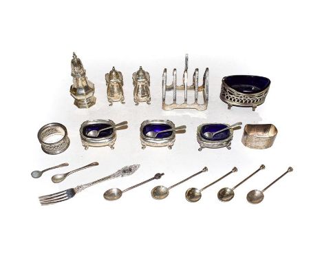 A selection of silver including toast rack, four salts with blue glass liners, one pepper, two napkin rings, coffee enamel sp