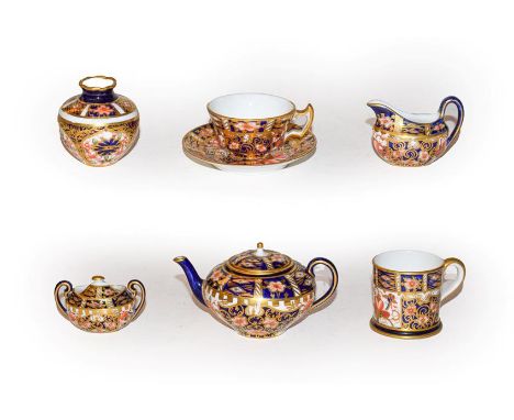 A Royal Crown Derby Imari pattern miniature four piece tea service, together with a Royal Crown Derby Imari pattern mug and v