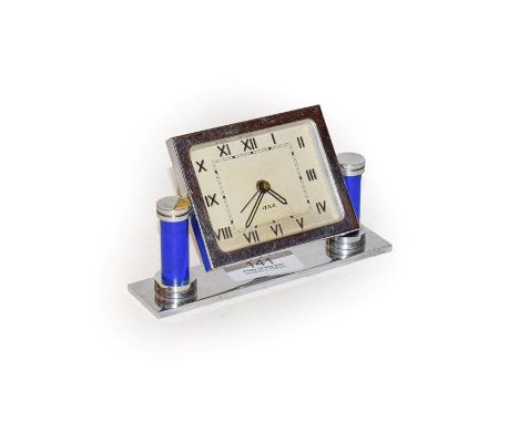 An Art Deco chrome plated bedside alarm timepiece, dial signed 'Jaz', raised upon blue columns, 8cm high