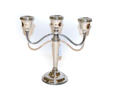 An Elizabeth II silver three branch candelabra, by A T Cannon Ltd, Birmingham, 1976, filled 23cm