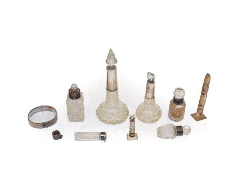 A quantity of silver mounted glass scent bottles, a silver bangle and two carved bone miniature totem poles (one box)