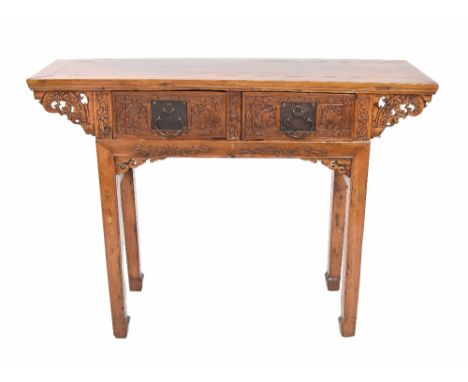 Chinese fruitwood alter stand, the moulded top over foliate carved scroll supports and two short drawers with foliate carved 
