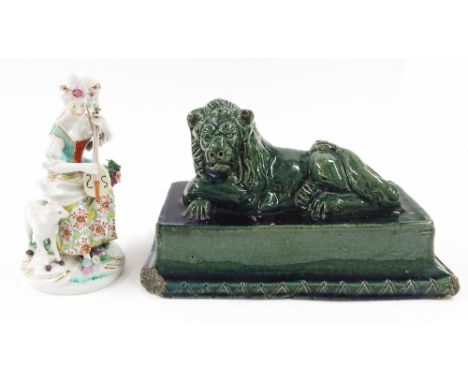 Early English green glazed figure of a 'Chatsworth Lion', 10" wide, 5" deep, 6.5" high; together with an early porcelain figu