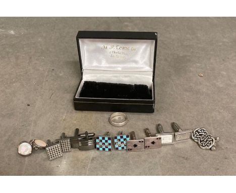 A selection of silver and white metal Gents cuff links along with a silver wedding band style ring.