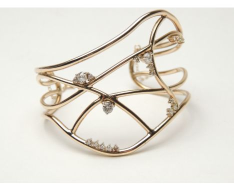 9ct gold constellation openwork bangle, set with 20 old round cut diamonds totalling approx. 0.75ct, cuff size 57mm, gross we