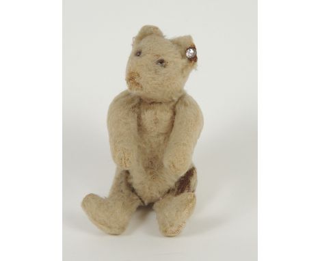 Steiff miniature teddy bear, circa 1920-30, with metal button in ear, glass eyes, jointed limbs, 14cm (Please note condition 