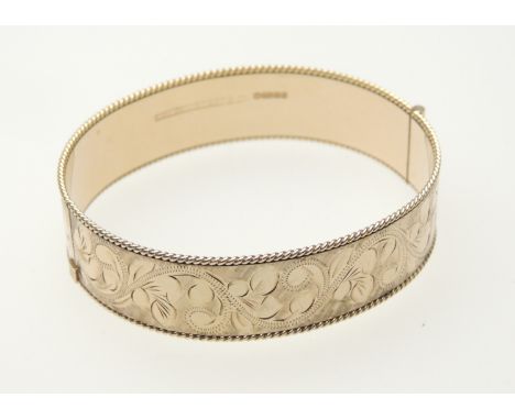 9ct gold engraved hinged bangle, Birmingham 1979, width 15mm, weight approx. 30.8g (Please note condition does not form part 