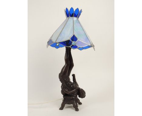 Decorative modern bronze figural lamp, cast as a juggler, with leaded blue glass shade, 63cm (Please note condition does not 