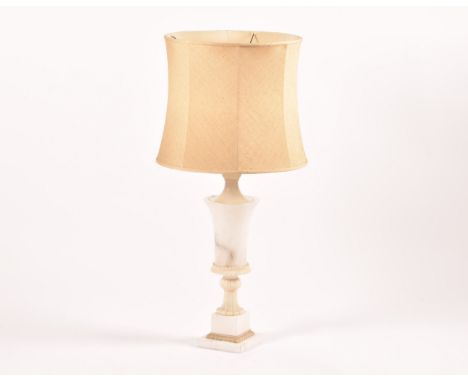 A large alabaster and marble table lamp with shade, of urn form and supported on a fluted stem to a square pedestal base, fit