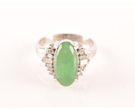 A platinum ring set to centre with an elongated oval cabochon jade measuring approximately 14 x 7.2 x 4mm, surrounded by tape