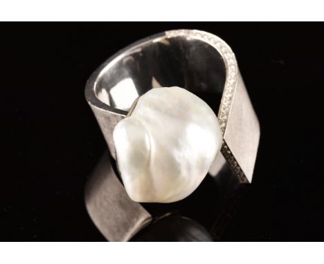 A 18ct white gold ring, featuring a baroque pearl measuring approximately 1.8 x 2cm, further adorned to the shank border with