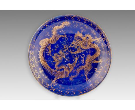 A Chinese Qing Dynasty blue glaze and gilt porcelain dragon pattern dish, a pair of dragons with the flaming Pearl of Wisdom 