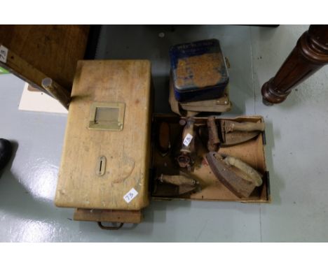 Box of old metal clothes irons, tin of cleaning brushes, army tin box & Old pine shop till drawer, 19”l x 10”w