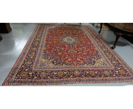 Large red ground Persian Kashan Carpet, multi-coloured traditional medallion designs, multiple pattern borders, 4m x 2.92m