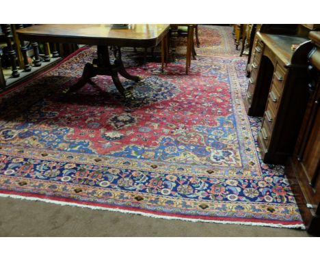 Red Ground Persian Mashad Carpet, all over medallion design, vibrant colours, signed by the weaver, 3.9m x 3m