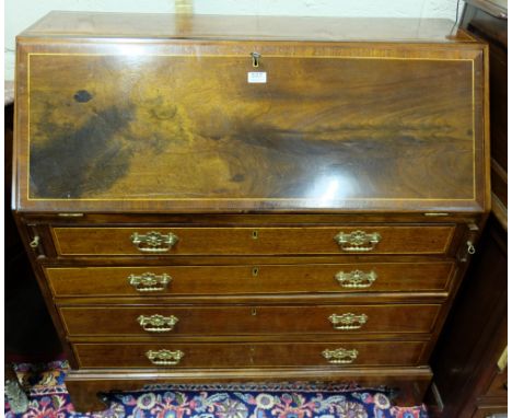 Edwardian Inlaid Mahogany Slope front Bureau, the folding desk top enclosing an arrangement of upper drawers, over a 4 drawer