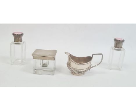 Glass inkwell of cube form with engine turned silver mounts and cover, pair of glass dressing table jars with silver and pink