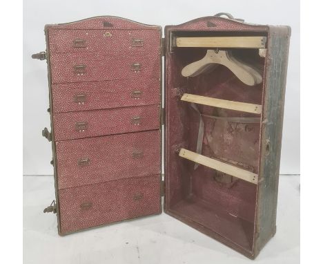 Vintage travelling trunk opening to reveal hanging space and drawers