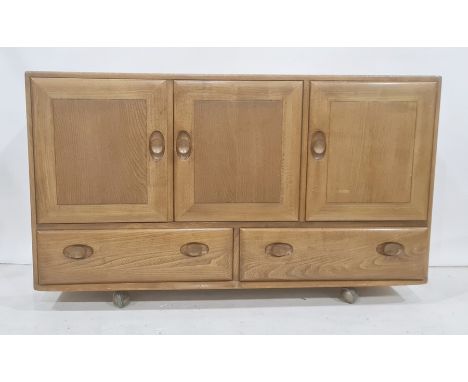 Ercol elm sideboard, the rectangular top above three cupboard doors, two drawers under, to castors, 129cm x 76cmCondition Rep