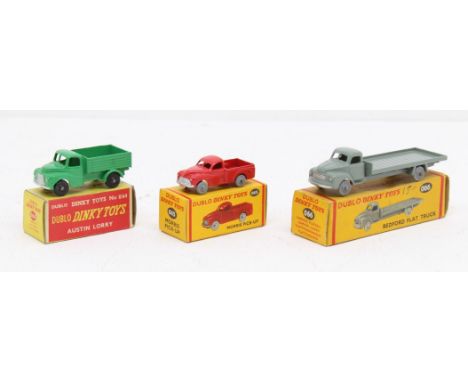 Dinky: A collection of three boxed Dublo Dinky Toys, to comprise: Austin Lorry, 064, green; Morris Pick-Up, 065, red; and Bed