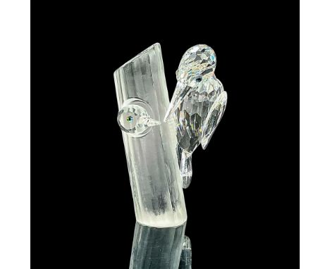 Brilliant clear crystal SCS Annual Edition figure of a young woodpecker peeking out of a nest in a tree and met by an adult w