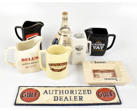 A reproduction cast metal advertising sign for Gulf, together with five modern advertising whisky and spirit jugs, a Teacher'