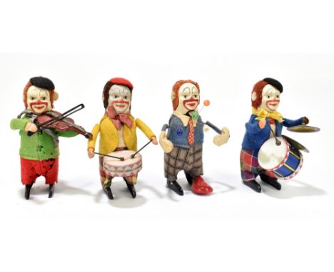 SCHUCO; four clockwork model clowns, three as musicians including drummer, violinist and cymbal player and a fourth clown jug