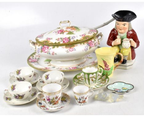 A 19th century Staffordshire Toby jug modelled as a seated portly gentleman with a jug and glass, two Dresden cups and one sa