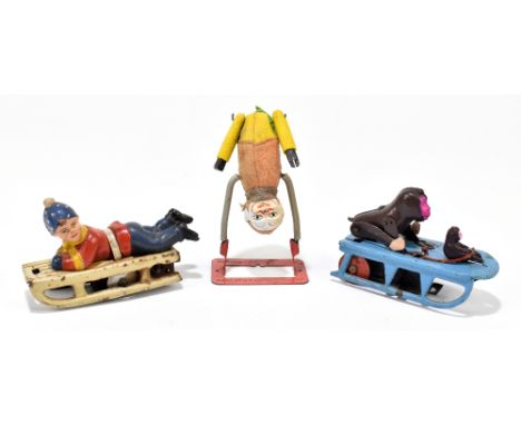 SCHUCO; a German clockwork acrobatic clown, height 9.5cm, and two clockwork groups, one of two monkeys on a sledge, the other