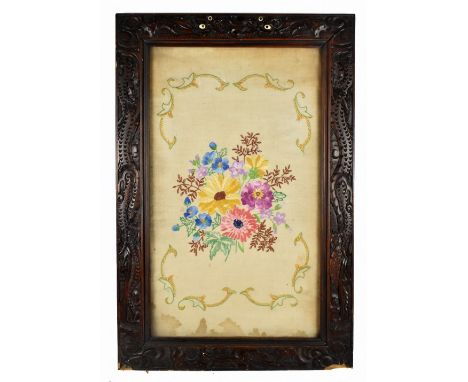 A Chinese carved rosewood rectangular frame decorated with dragons, with later needlework tapestry panel with floral decorati